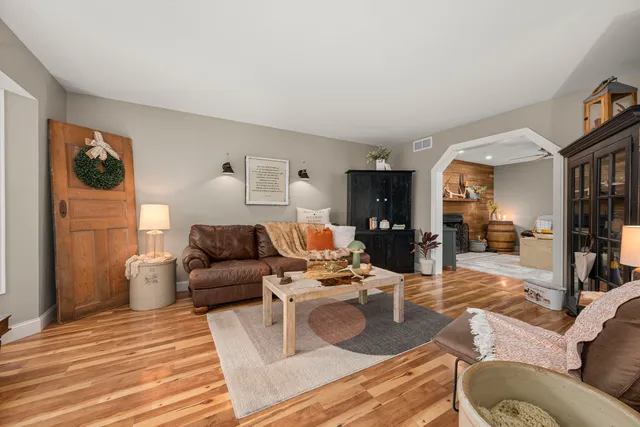 a living room with furniture and a wooden floor