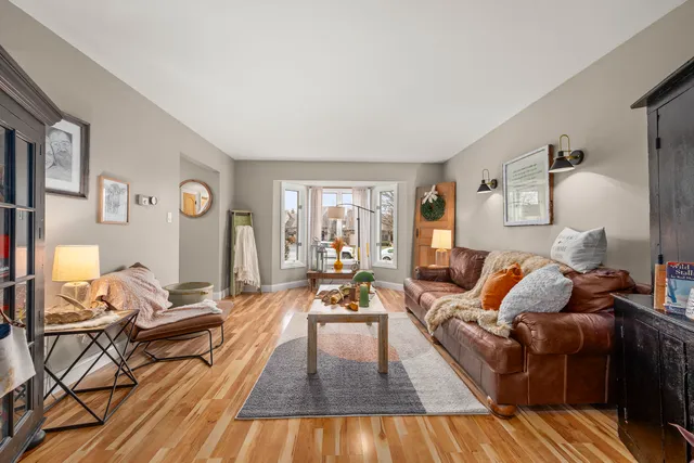 a view of a dining room with furniture and a chandelier fan