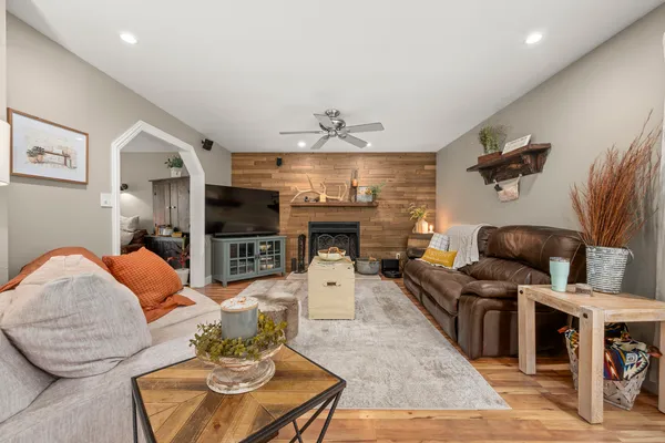 a living room with furniture and a wooden floor