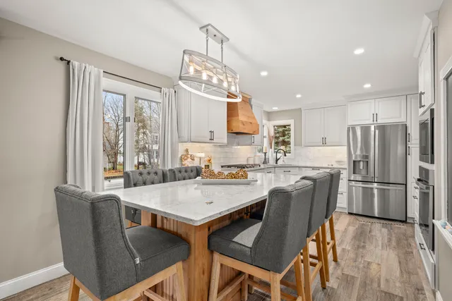 a dining room with furniture and a chandelier