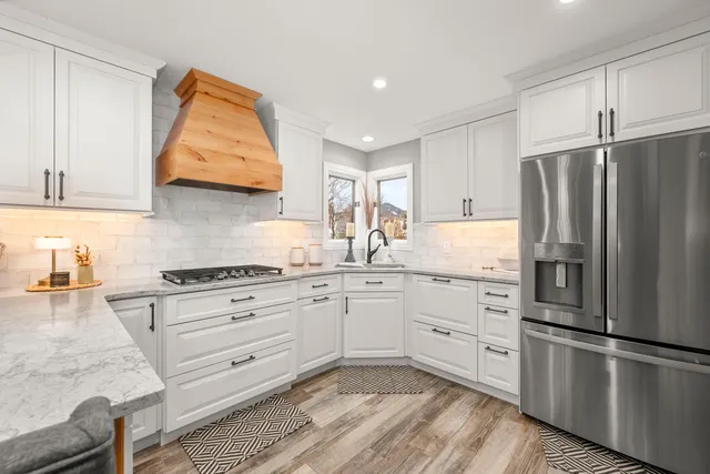 a kitchen with white cabinets and appliances