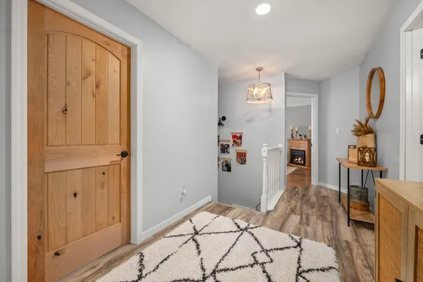 a bedroom with a bed ceiling fan and a fireplace