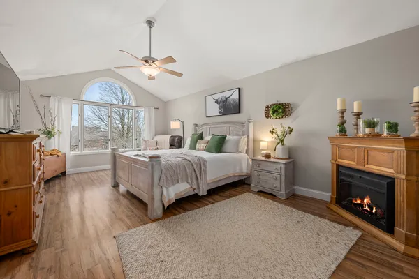 a spacious bedroom with a bed and a chandelier