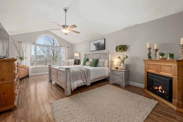 a spacious bedroom with a bed and a chandelier