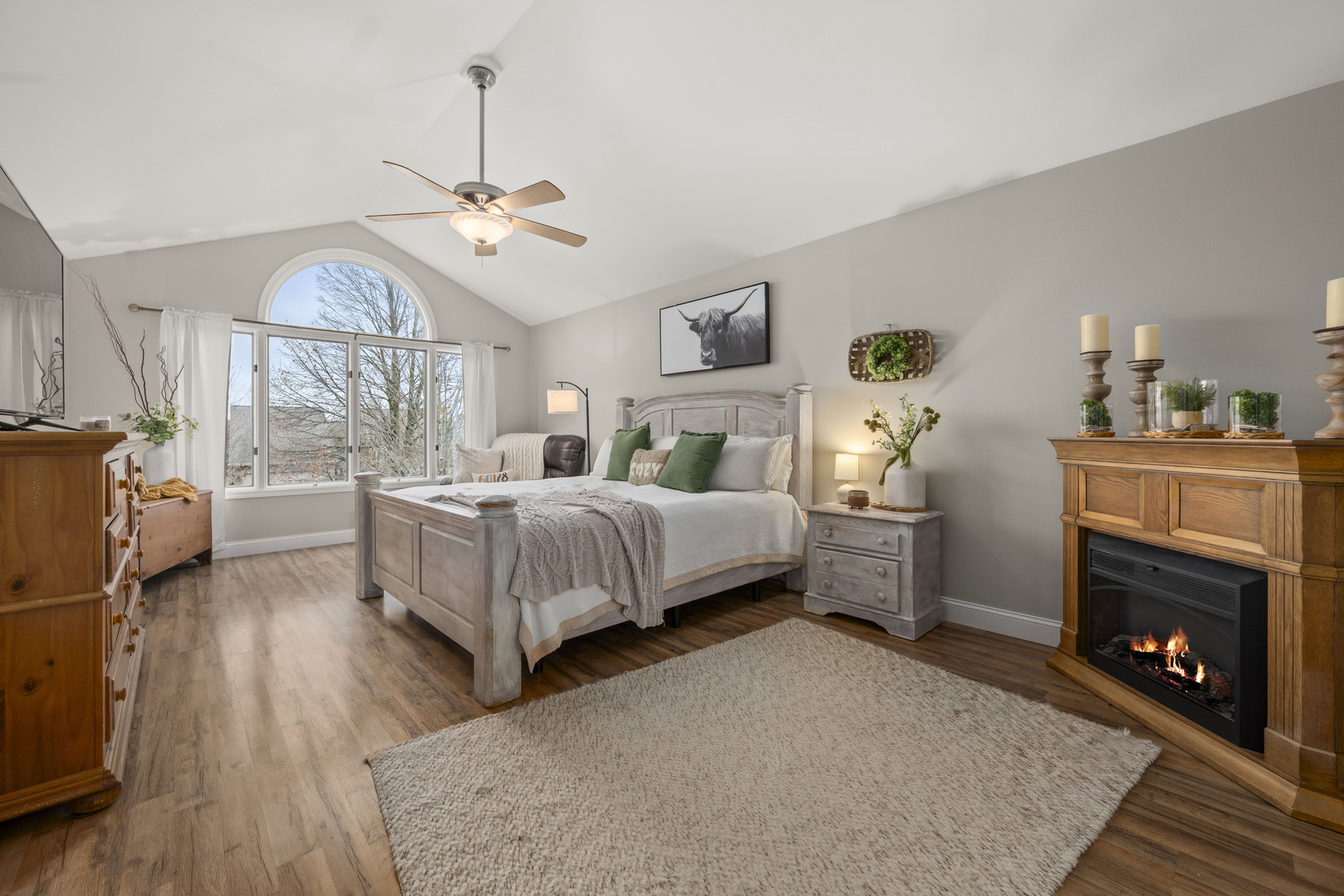 932 Foxpointe Drive Sycamore, IL 60178 - Photo 31 of 52 a bedroom with a bed ceiling fan and a fireplace