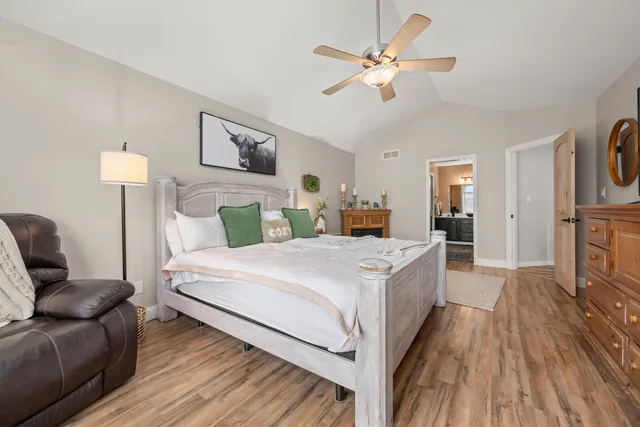 a spacious bathroom with a double vanity sink a mirror and a