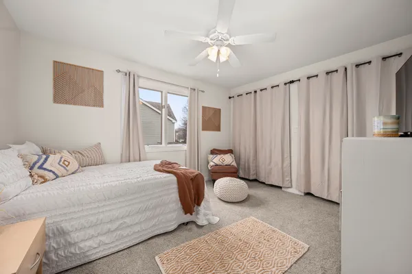 a bedroom with furniture and a large window