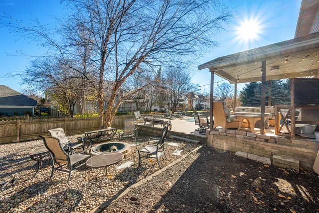 a view of a patio with a table and chairs under an umbrella