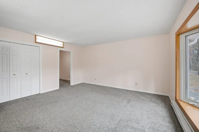 a view of an empty room and a window