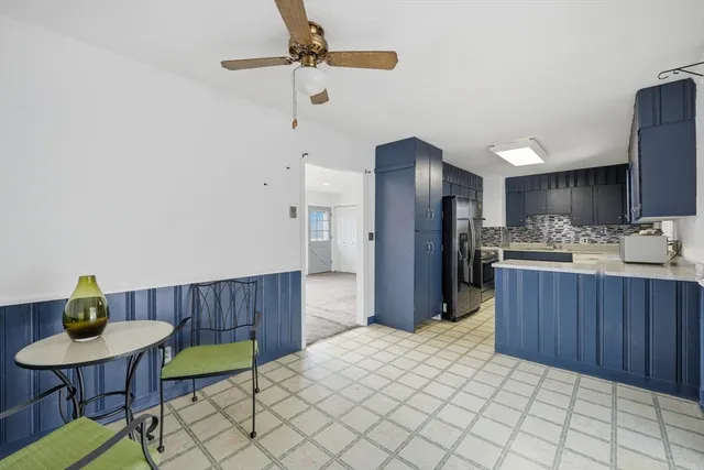 a kitchen with stainless steel appliances a sink cabinets and wooden floor