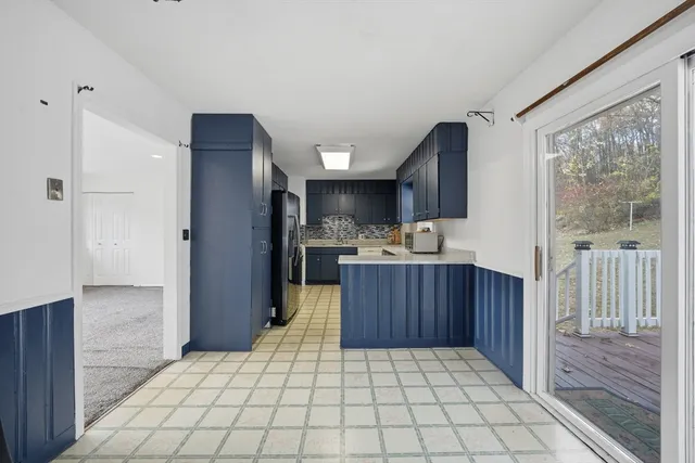 a kitchen with stainless steel appliances a refrigerator and a wooden cabinets
