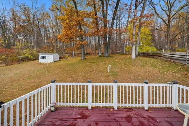 a view of street with wooden fence