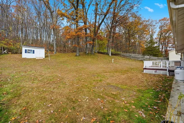a view of a house with a yard and garage