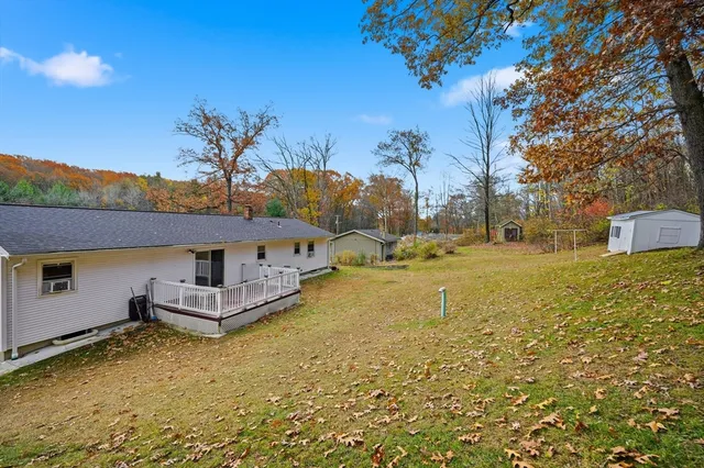 a view of street sign under a large tree