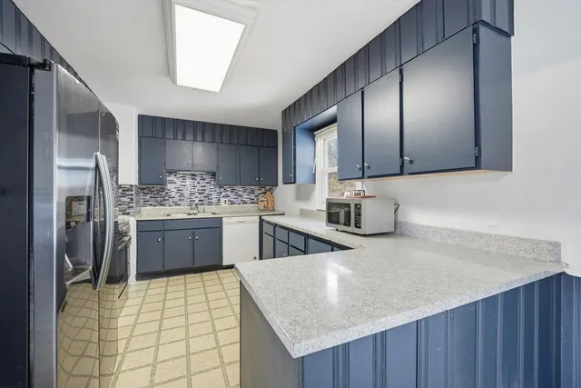 a kitchen with a cabinets a sink stainless steel appliances and cabinets