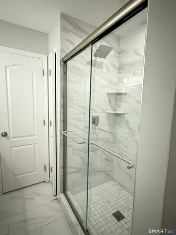 a bathroom with a glass shower door
