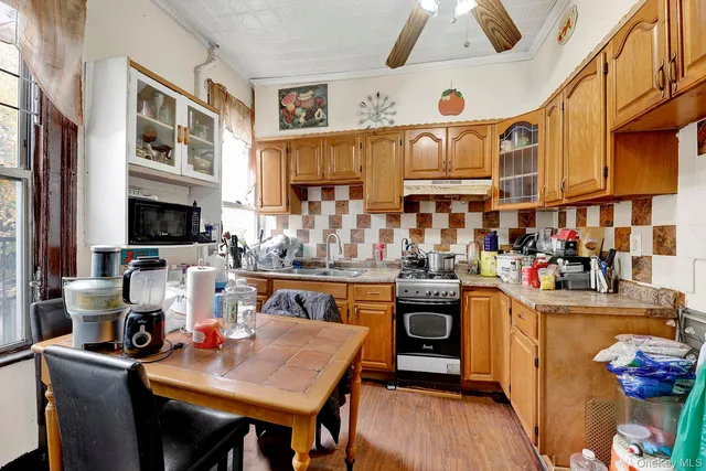 a view of a dining room with furniture and a kitchen
