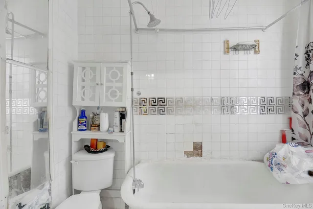 a bedroom with a bed and a dresser in it