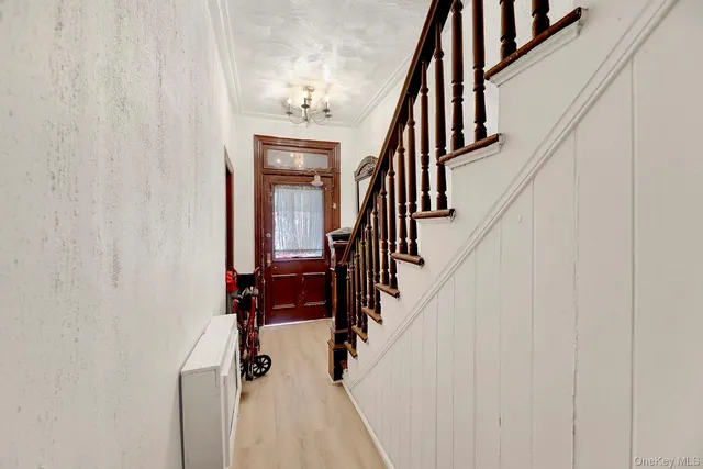 a view of staircase with wooden floor and fan