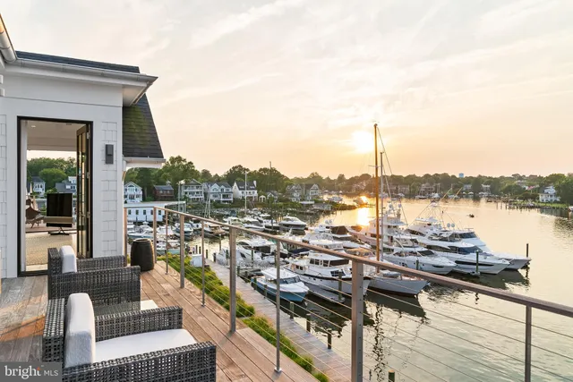 a living room with patio furniture and a floor to ceiling window