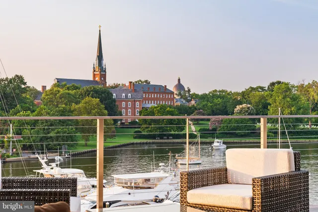 a view of roof deck with seating space and city view