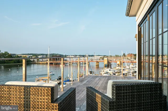 a view of a lake from a balcony with two chairs