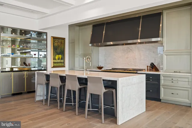 a kitchen with a sink and chairs