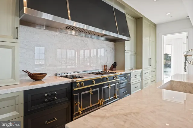 a kitchen with stainless steel appliances granite countertop a stove and a sink