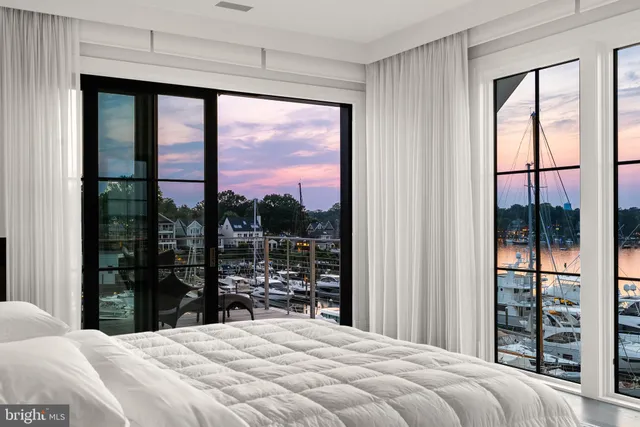 a large bedroom with a bed and a window