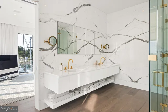 a white bath tub sitting next to a white wall