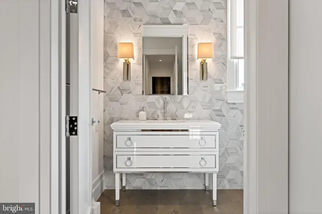a bathroom with a sink vanity and mirror