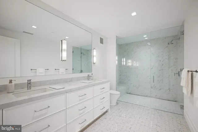 a bathroom with a double vanity sink mirror double and shower