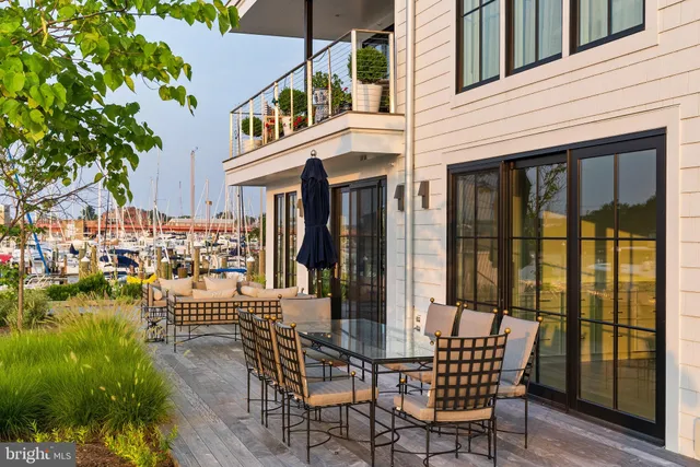 a view of a patio with table and chairs and potted plants