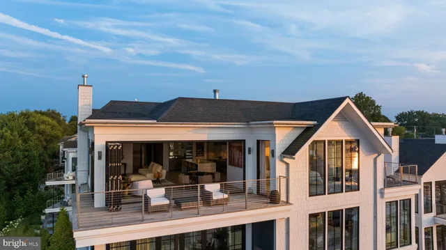 a view of house with a big yard and potted plants