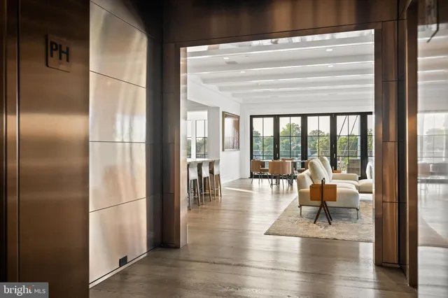 a dining room with furniture water view and a floor to ceiling window