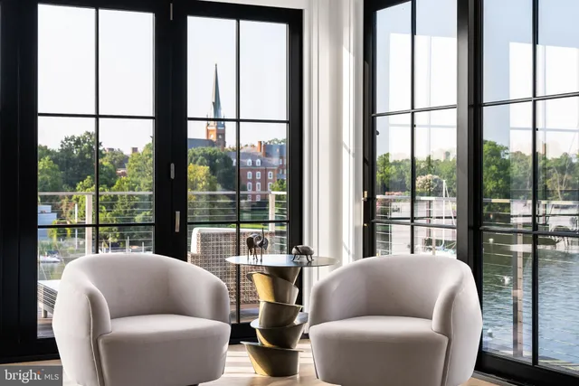 a living room with furniture and large window