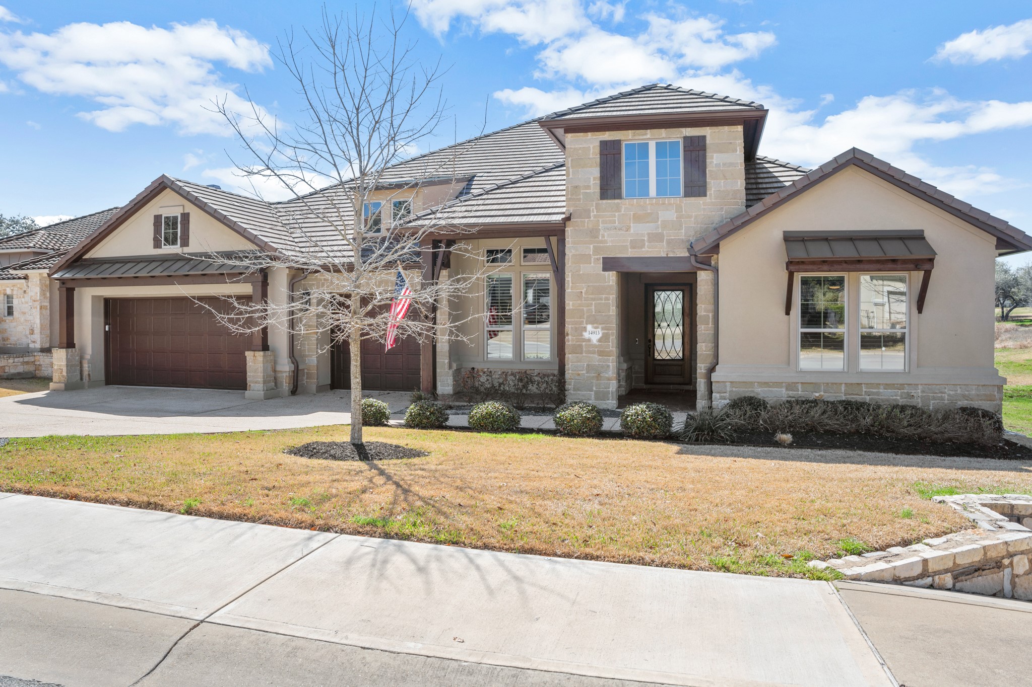 14913 Spillman Ranch Loop Austin, TX 78738 - Photo 8 of 40 Stunning stone and stucco architecture creates timeless curb appeal in Falconhead/Spillman Ranch.