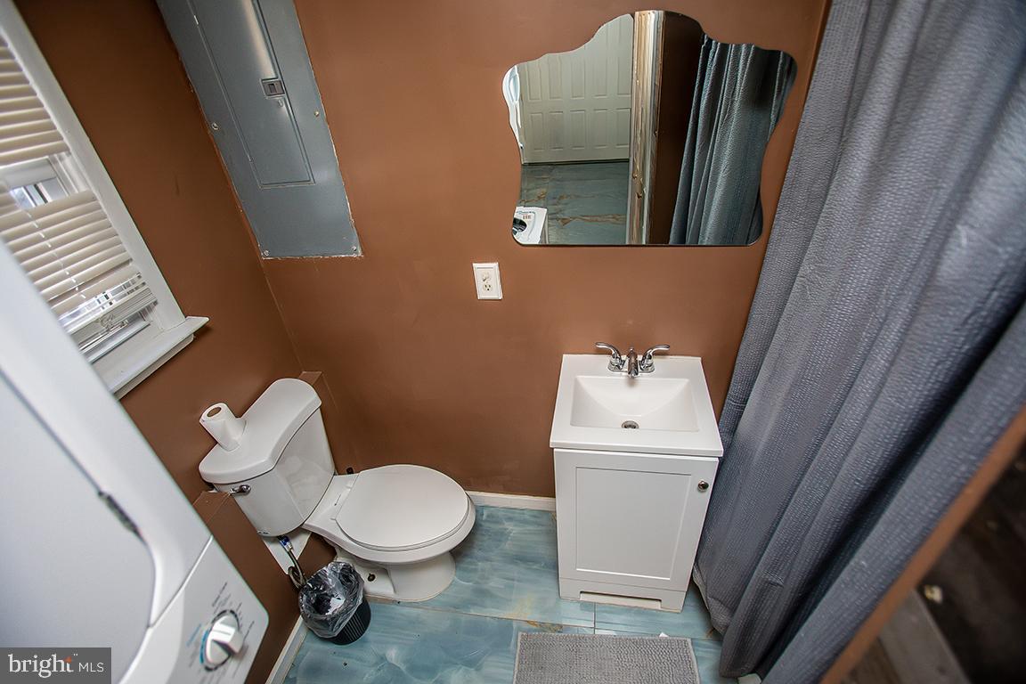 2818 Rome Road Vineland, NJ 08361 - Photo 20 of 31 a white toilet sitting next to a white sink and vanity