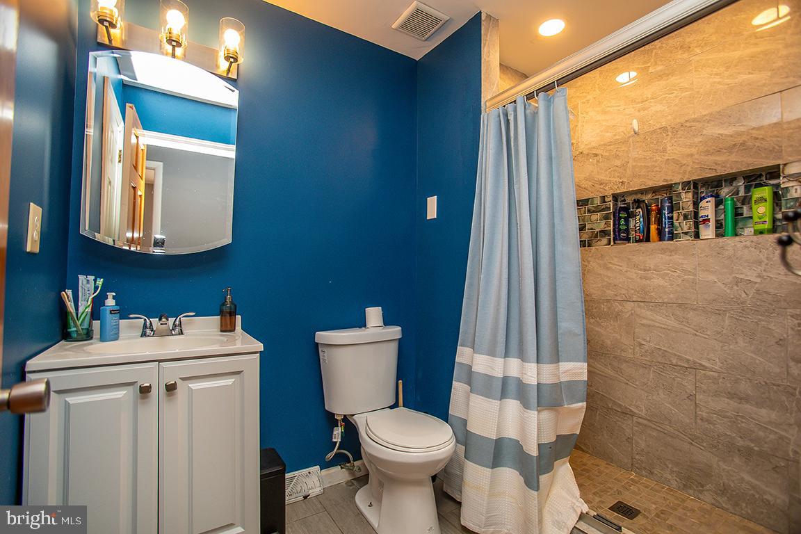 2818 Rome Road Vineland, NJ 08361 - Photo 23 of 31 a white toilet sitting next to a bathroom sink