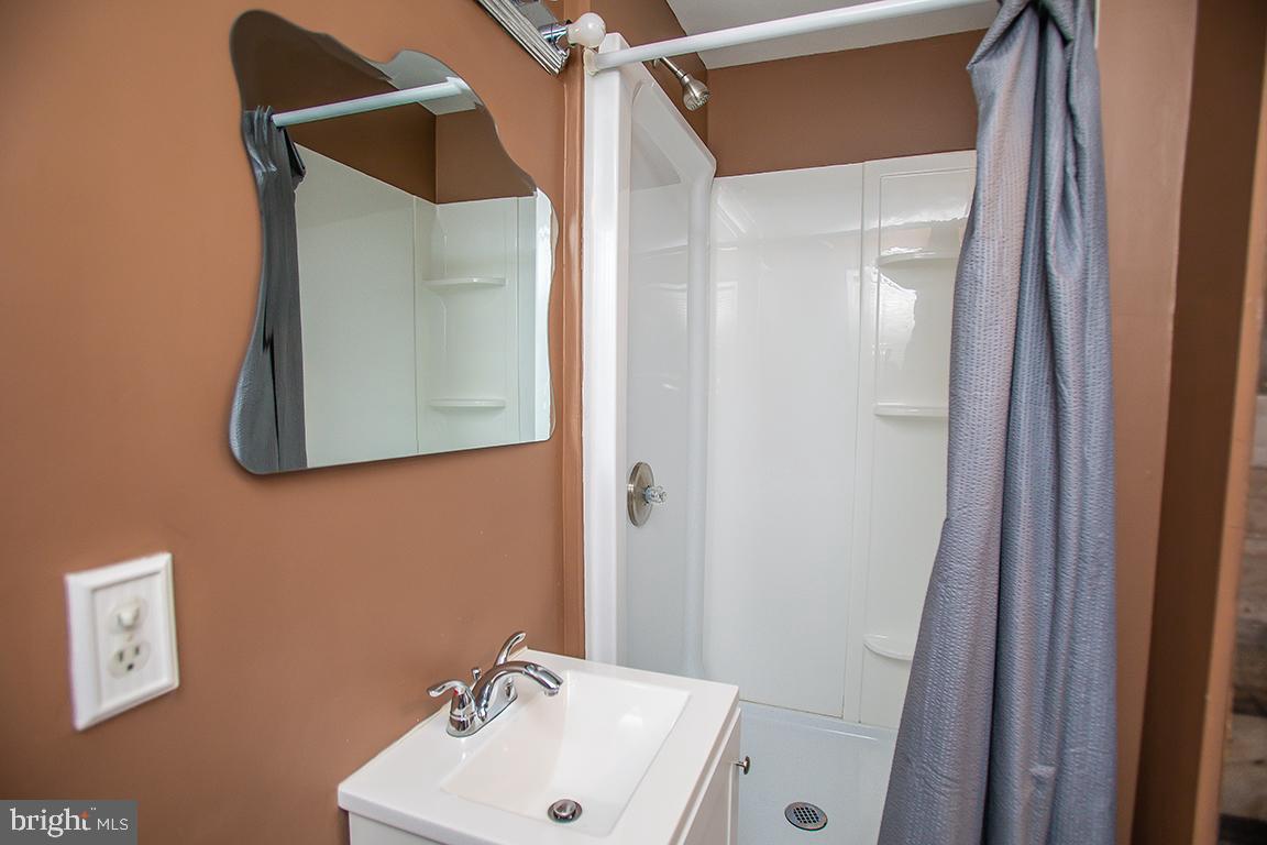 2818 Rome Road Vineland, NJ 08361 - Photo 6 of 31 a bathroom with a sink and mirror with toilet
