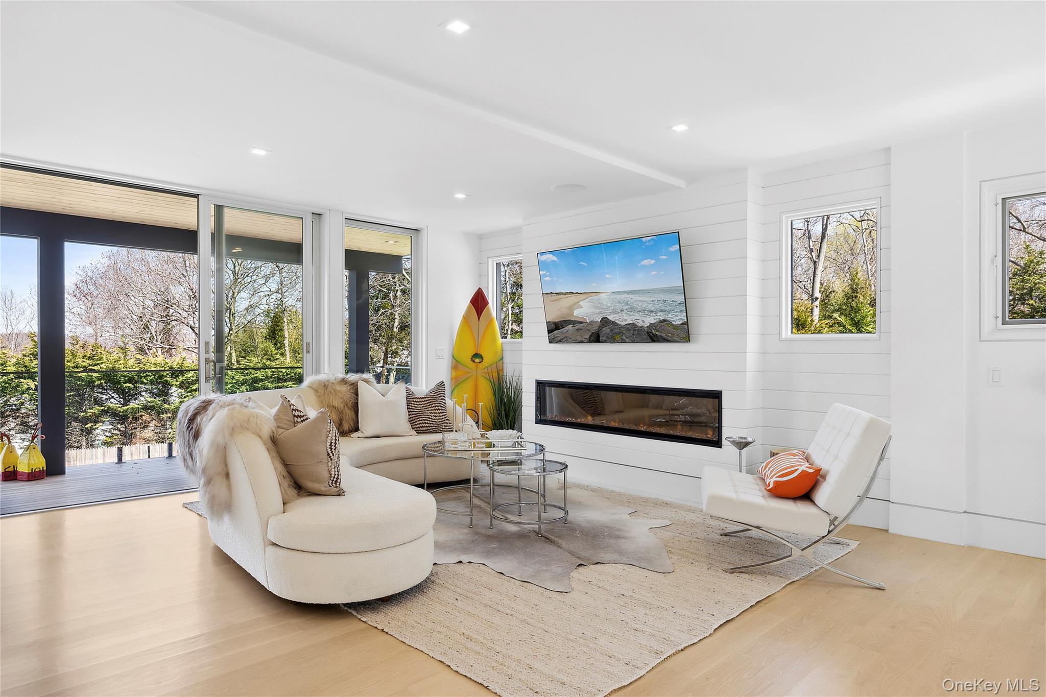 2803 Noyack Road Sag Harbor, NY 11963 - Photo 1 of 15 a living room with furniture and a large window