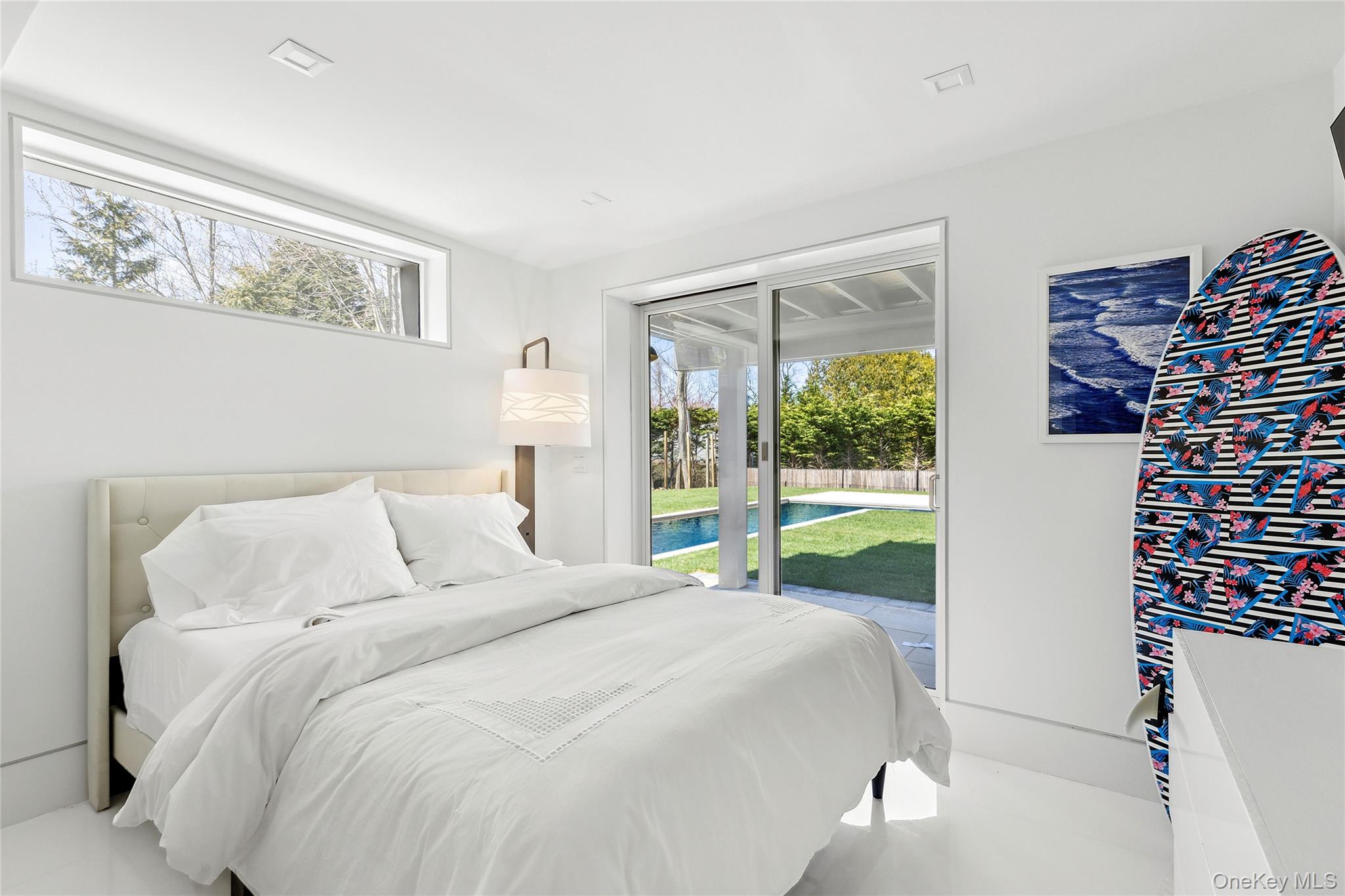 2803 Noyack Road Sag Harbor, NY 11963 - Photo 13 of 15 a bed sitting in a bedroom next to a window