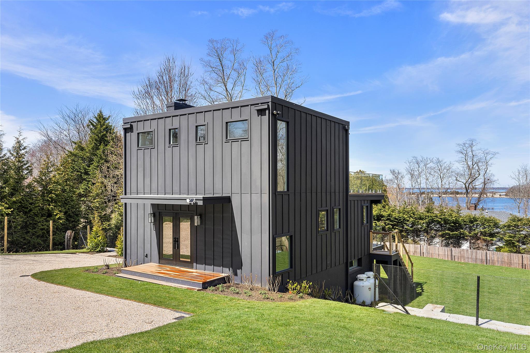 2803 Noyack Road Sag Harbor, NY 11963 - Photo 14 of 15 a view of a house with backyard and porch