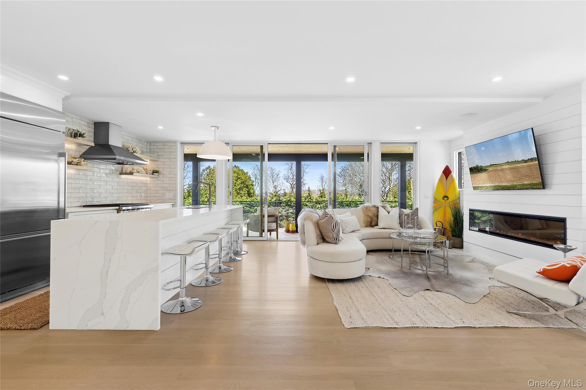 2803 Noyack Road Sag Harbor, NY 11963 - Photo 2 of 15 a living room with fireplace furniture and a large window