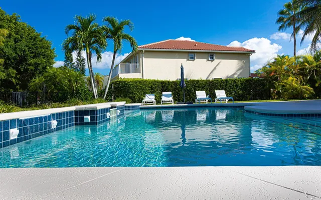 a view of house with swimming pool yard and outdoor seating