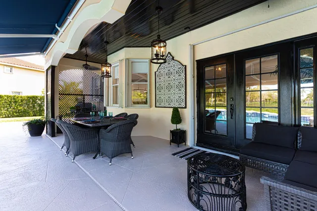 a outdoor dining space with furniture and large windows