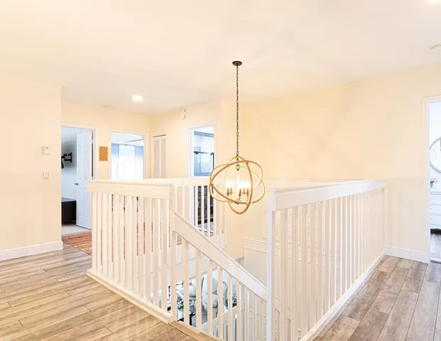 a view of staircase with railing and white walls