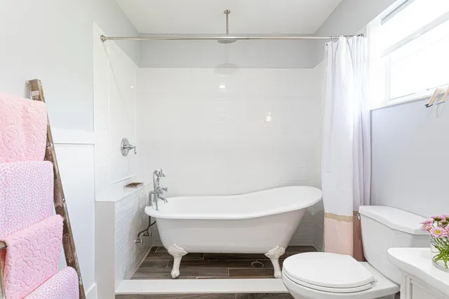 a bathroom with a white toilet a sink and a bathtub