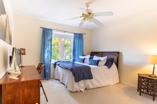 a bed room with a bed and a chandelier