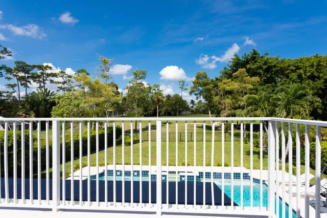 a balcony with trees in the background